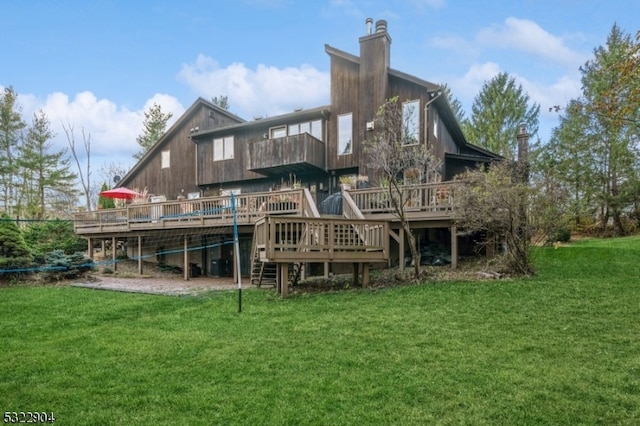 rear view of property with a lawn and a deck