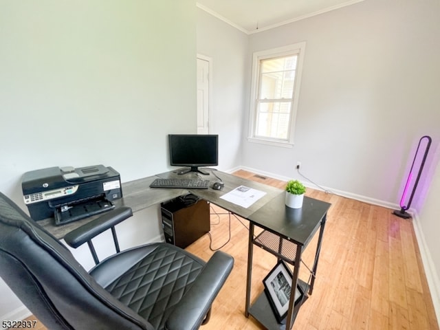 office space with crown molding and light hardwood / wood-style flooring