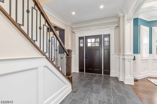 entrance foyer with dark wood-type flooring and ornamental molding