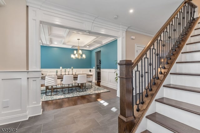 dining area with dark hardwood / wood-style flooring, coffered ceiling, crown molding, beam ceiling, and a chandelier