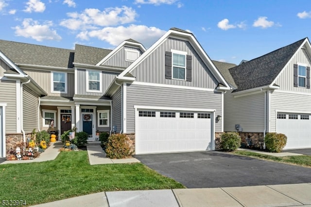 view of front of home with a front lawn and a garage