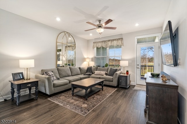 living room with ceiling fan and dark hardwood / wood-style flooring