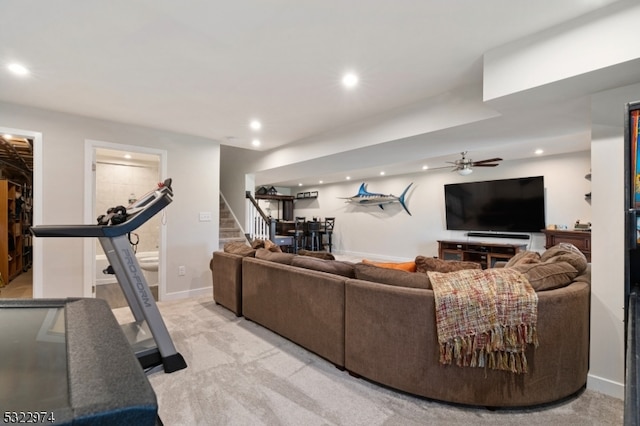 carpeted living room with ceiling fan