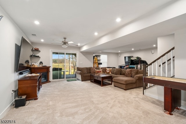 living room featuring light carpet and ceiling fan