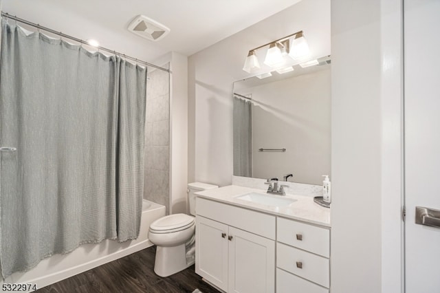 full bathroom featuring vanity, shower / bath combo with shower curtain, toilet, and wood-type flooring