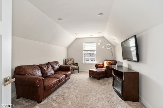 carpeted living room featuring vaulted ceiling