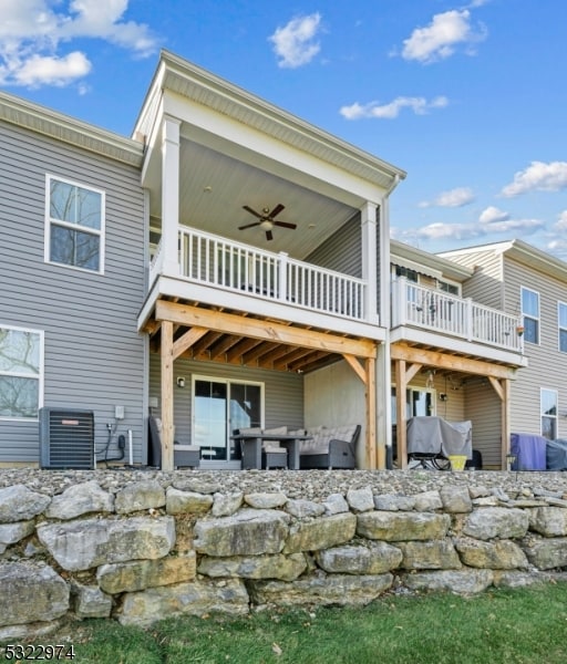 back of property featuring a patio, cooling unit, ceiling fan, and a balcony