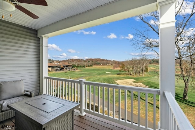 wooden terrace with a yard and ceiling fan