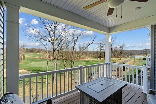 wooden terrace featuring a yard and ceiling fan