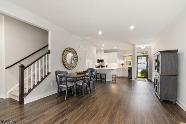 dining space with dark hardwood / wood-style floors