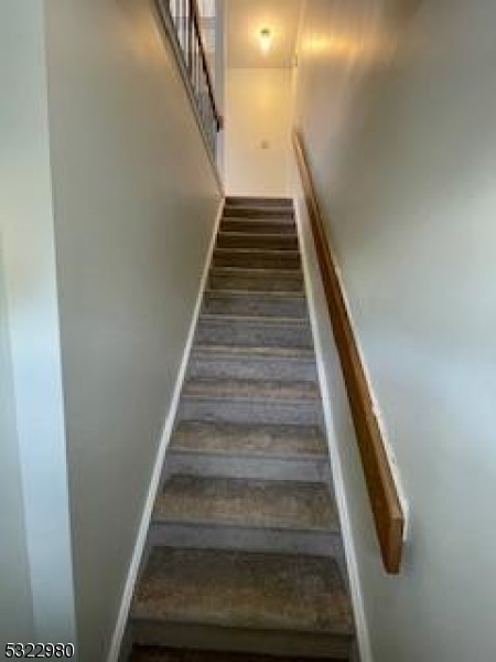 stairway with hardwood / wood-style flooring