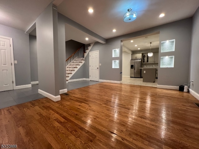 unfurnished living room featuring hardwood / wood-style flooring