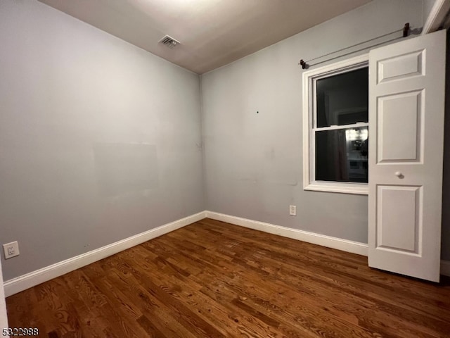 empty room featuring dark hardwood / wood-style flooring