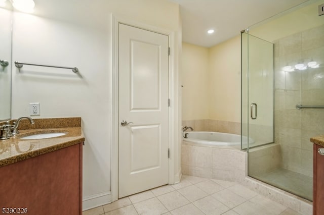 bathroom featuring independent shower and bath, vanity, and tile patterned floors