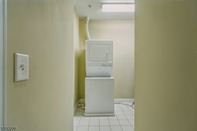 washroom featuring light tile patterned floors and stacked washer / dryer