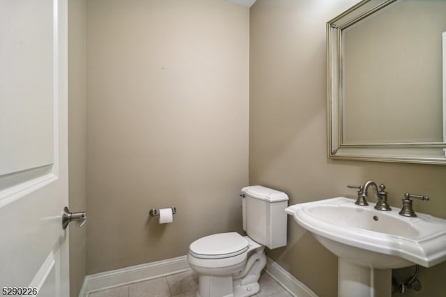 bathroom featuring tile patterned floors, toilet, and sink