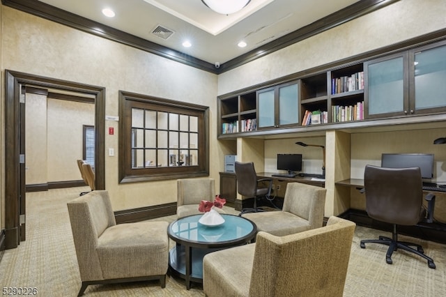 office with built in desk, light carpet, and crown molding