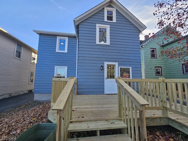 back of property featuring a wooden deck