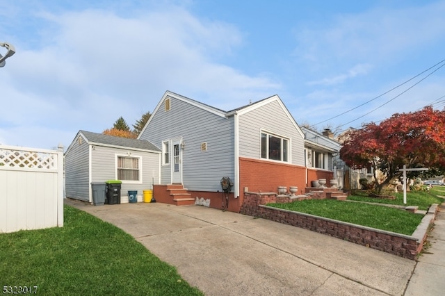 view of side of home with a yard