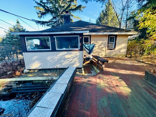 back of property featuring a wooden deck