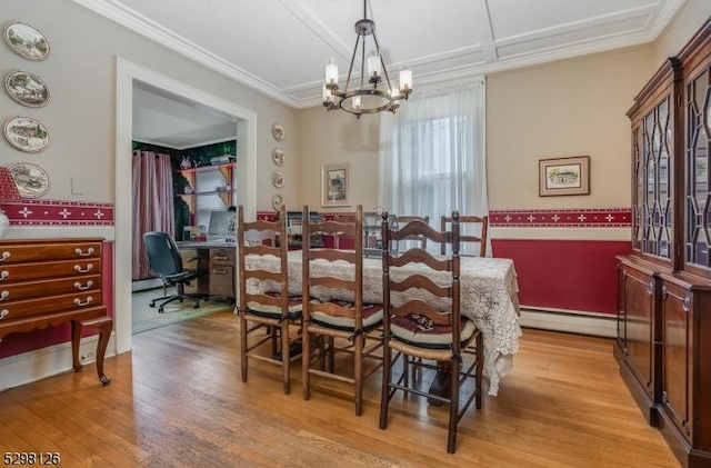 dining area featuring light wood finished floors, a notable chandelier, crown molding, and a baseboard radiator