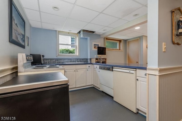 kitchen with a sink, stove, finished concrete floors, and white dishwasher