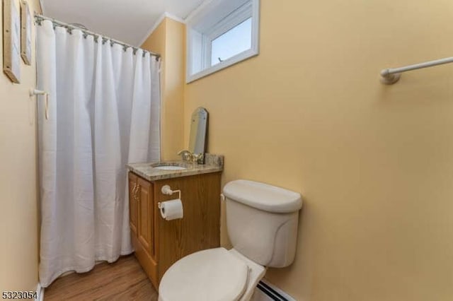 full bath with a shower with curtain, toilet, wood finished floors, and vanity