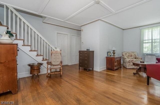 living area with hardwood / wood-style floors and stairs