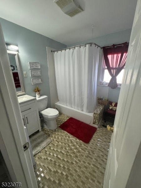 full bathroom featuring toilet, shower / tub combo with curtain, vanity, and tile patterned flooring