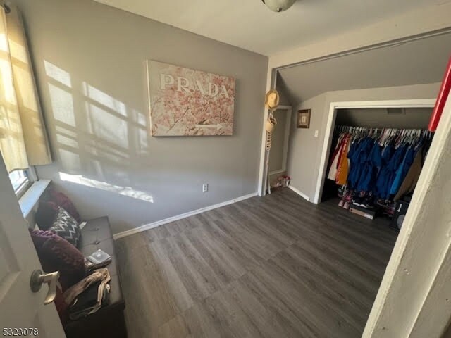 unfurnished bedroom with a closet and dark hardwood / wood-style floors