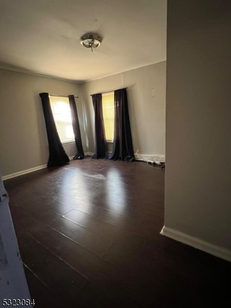 unfurnished room with dark hardwood / wood-style floors