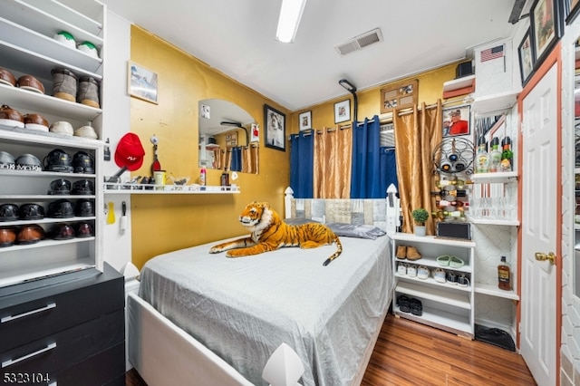 bedroom with wood-type flooring