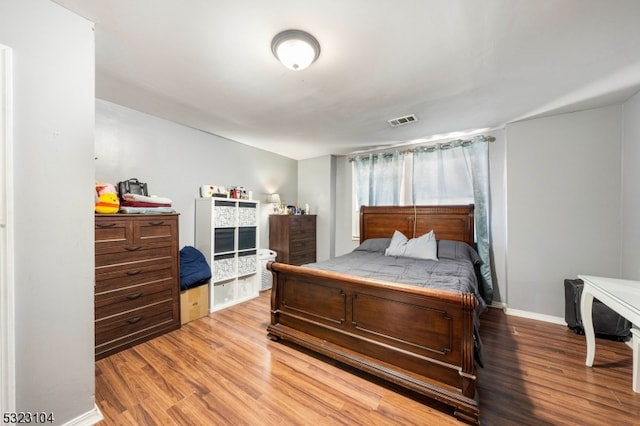 bedroom with hardwood / wood-style floors