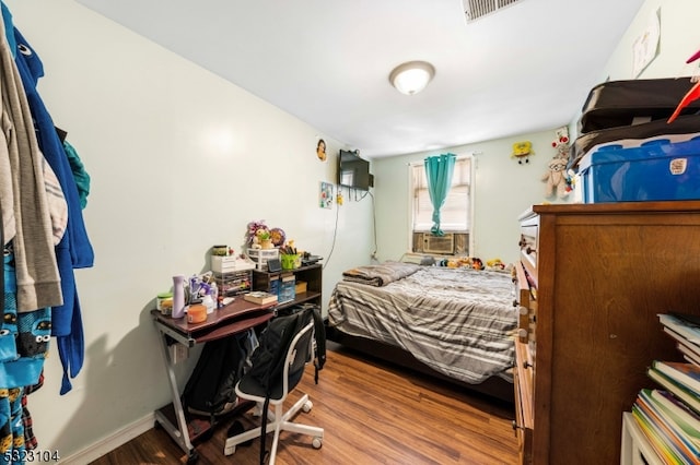 bedroom with wood-type flooring