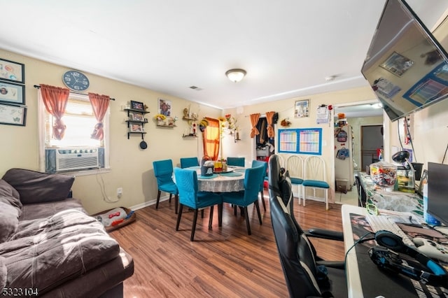 dining room featuring hardwood / wood-style floors and cooling unit