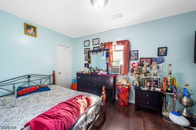 bedroom with dark hardwood / wood-style flooring