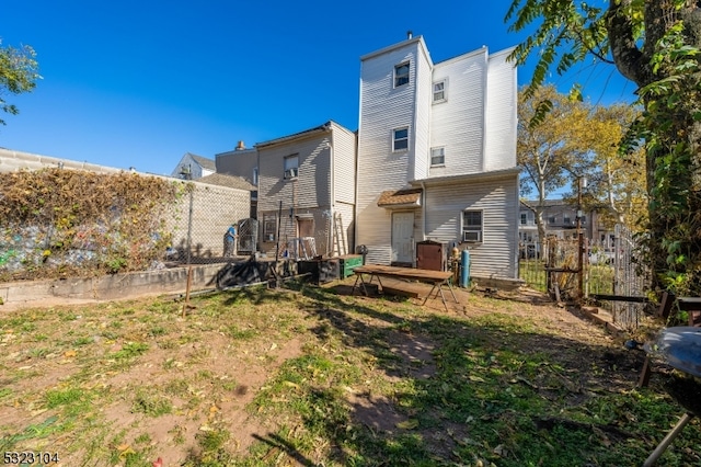 rear view of house featuring a wooden deck