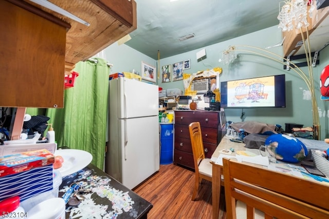 kitchen featuring wood-type flooring and white refrigerator