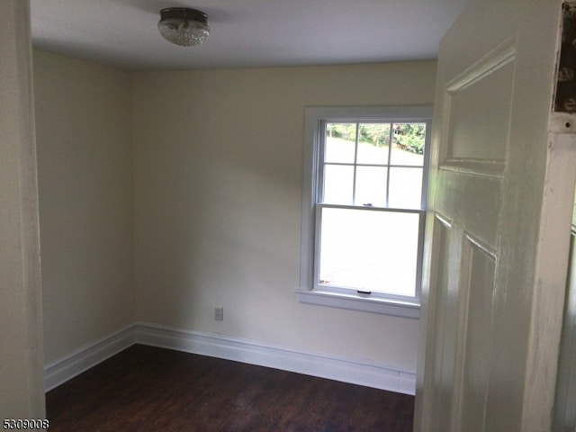 spare room featuring dark hardwood / wood-style flooring