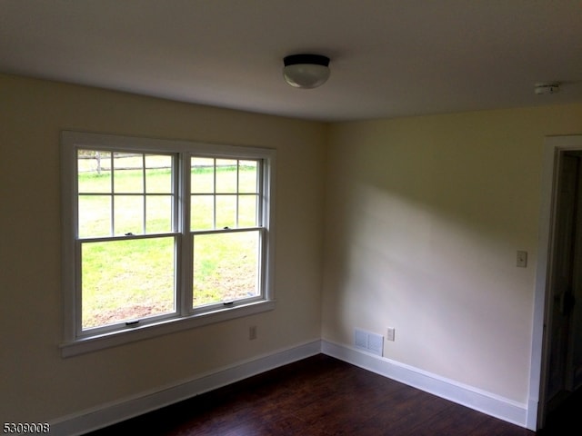 empty room featuring dark wood-type flooring