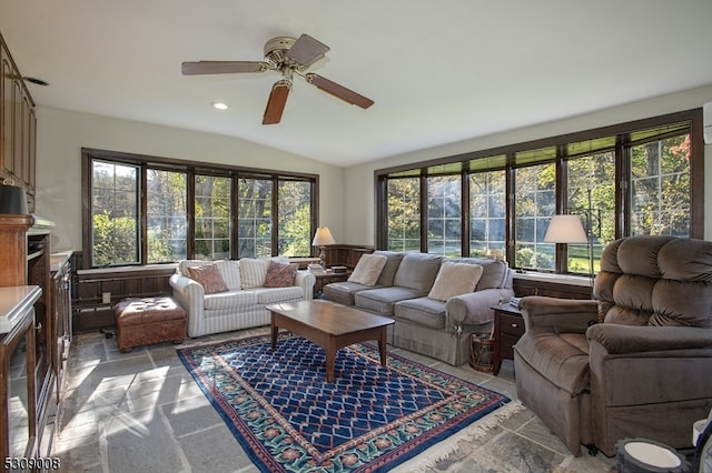 living room with ceiling fan, a healthy amount of sunlight, and lofted ceiling