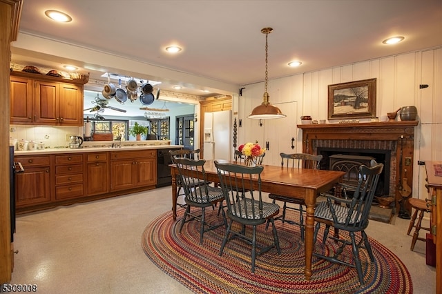 dining space featuring sink and a brick fireplace