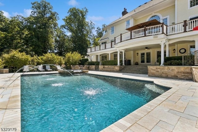 view of pool featuring a pool with connected hot tub, a ceiling fan, a patio, and french doors