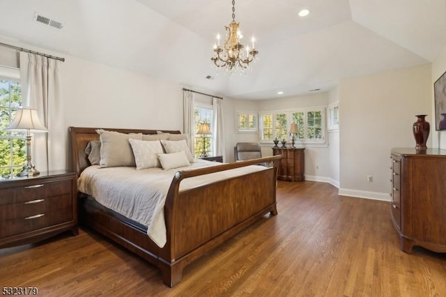 bedroom featuring recessed lighting, wood finished floors, visible vents, baseboards, and vaulted ceiling