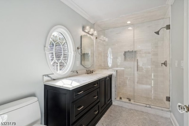 full bathroom with ornamental molding, a stall shower, vanity, and toilet