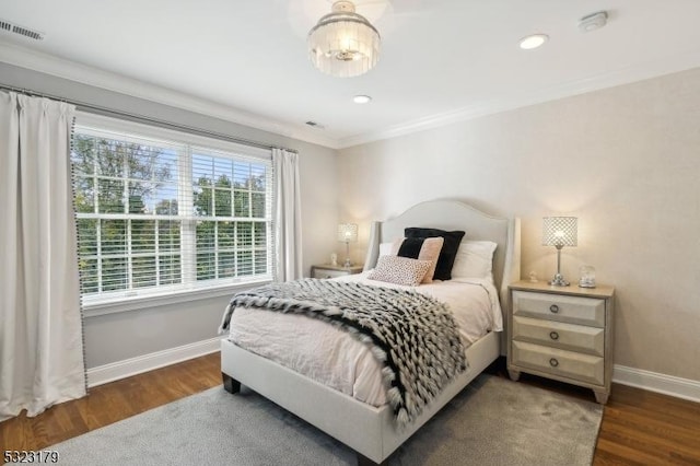 bedroom with recessed lighting, wood finished floors, visible vents, baseboards, and crown molding