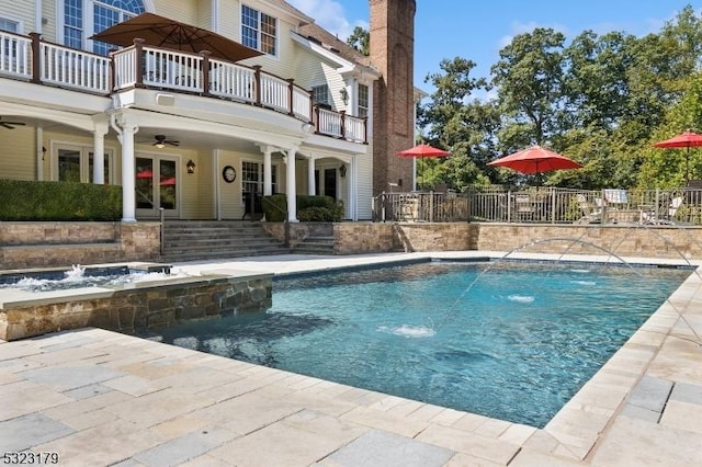 view of pool with a fenced in pool, french doors, a patio area, and ceiling fan