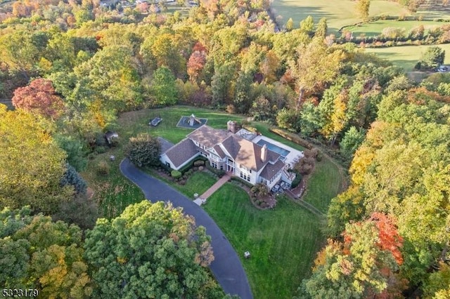 drone / aerial view featuring a view of trees