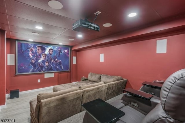 home theater room featuring a paneled ceiling and light wood-type flooring