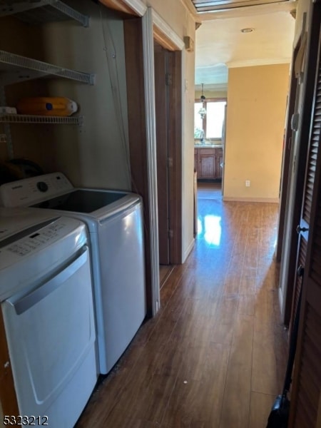 laundry room featuring hardwood / wood-style flooring and washer and clothes dryer